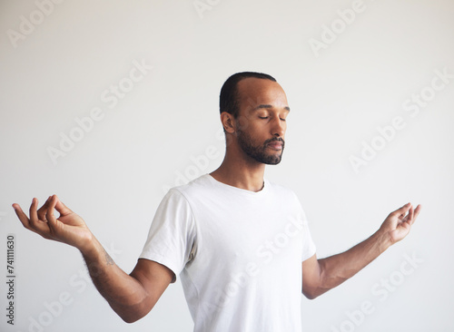 Young afro man concentrating his mind, meditating, yoga exercise breath technique reduce stress. photo