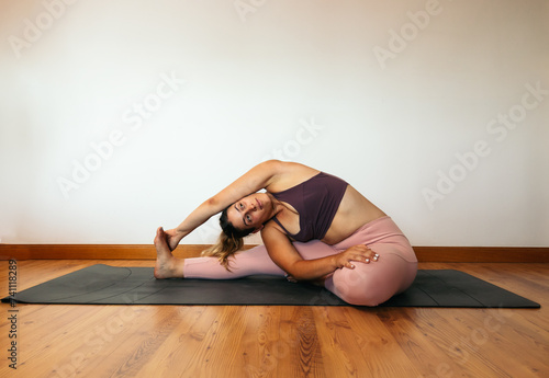 woman in sportswear doing yoga at home