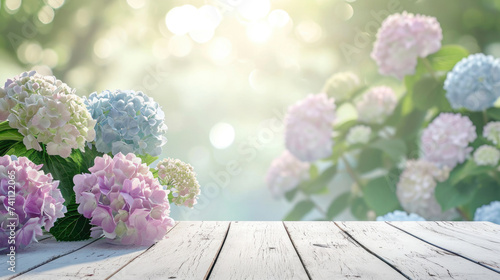 Spring summer soft background with flowers and wooden table for product presentation