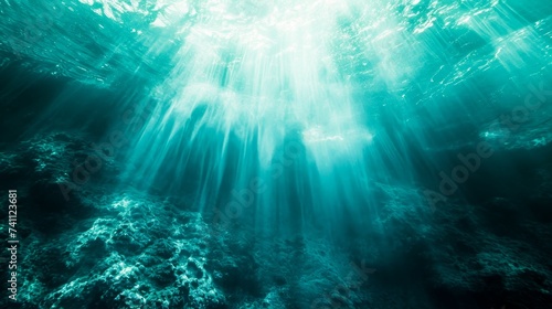  Sunlight filtering through the depths of a tranquil underwater scene.Suitable for environmental or marine-related content.  © Margo_Alexa