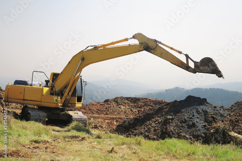 Backhoe excavator digging mountain ground for industrial surface adjust