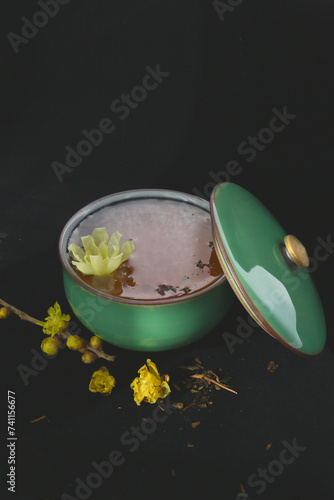 Chinese floral tea with wintersweet flowers, black background  photo