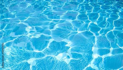 Beautiful blue texture of water. The waves shimmer in the sun. Relax by the pool in summer