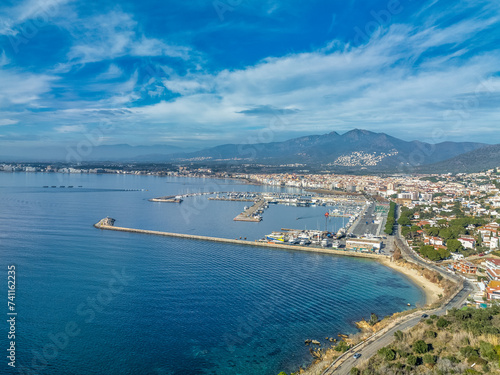 Aerial view of the Golf of Roses in Spain with deep blue water, sky, sail boats