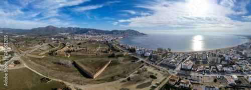 Panoramic aerial view of Roses citadel in Spain , giant pentagonal star fort fortress with bastions on each angle, ruins of medieval city, Roman ruins, monastery on the courtyard