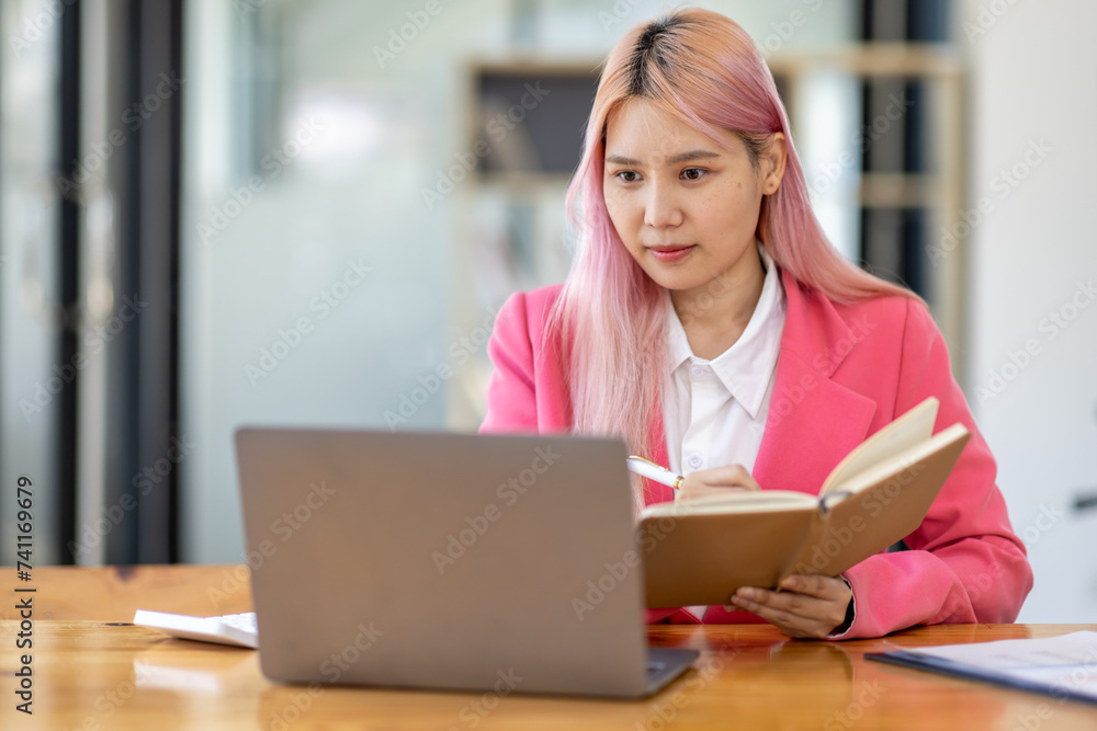 Accountant asian women at desk using laptop document archives on folders papers and calculator for accounting