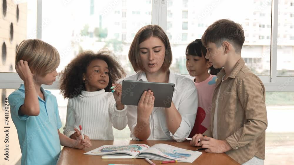 Smart teacher holding tablet while open online lesson to group of ...