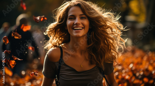 Happy Woman Walking in Park with Colorful Leaves Swirling Around Her in Sunny Autumn Weather