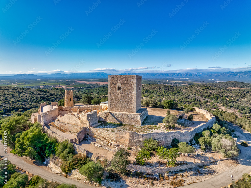 Aerial view of Ulldecona castle, Serra Grossa mountain top, former frontier fortified complex old church, emblematic circular tower and square keep