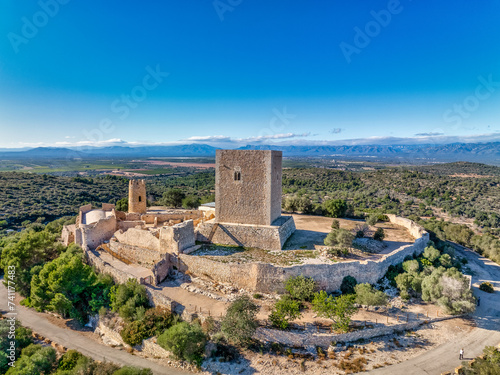 Aerial view of Ulldecona castle, Serra Grossa mountain top, former frontier fortified complex old church, emblematic circular tower and square keep