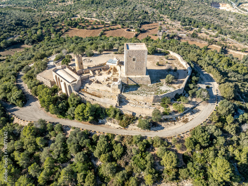 Aerial view of Ulldecona castle, Serra Grossa mountain top, former frontier fortified complex old church, emblematic circular tower and square keep photo