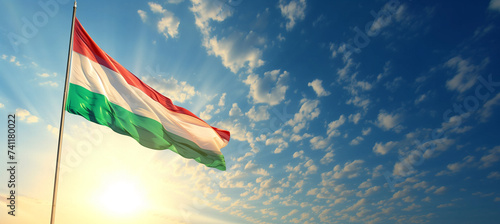National flag of hungary waving in the wind as symbol of patriotism and unity photo