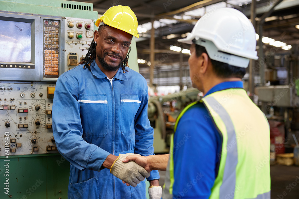 technician or engineer shaking hands with coworker before starting work in the factory technician or engineer shaking hands with coworker before starting work in the factory