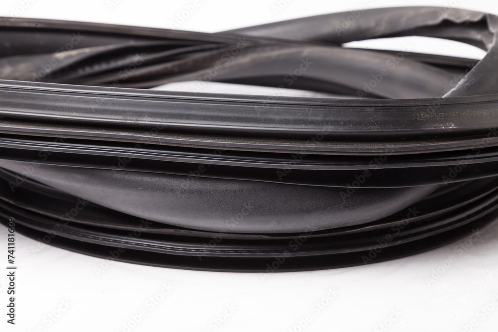 Rolled up black rubber sealant for elements of the car body, doors or trunk, for noise insulation, thermal and sound, preventing heat loss in the car interior. Sealing gasket for repair in a workshop. Rolled up black rubber sealant for elements of the car body, doors or trunk, for noise insulation, thermal and sound, preventing heat loss in the car interior. Sealing gasket for repair in a workshop.