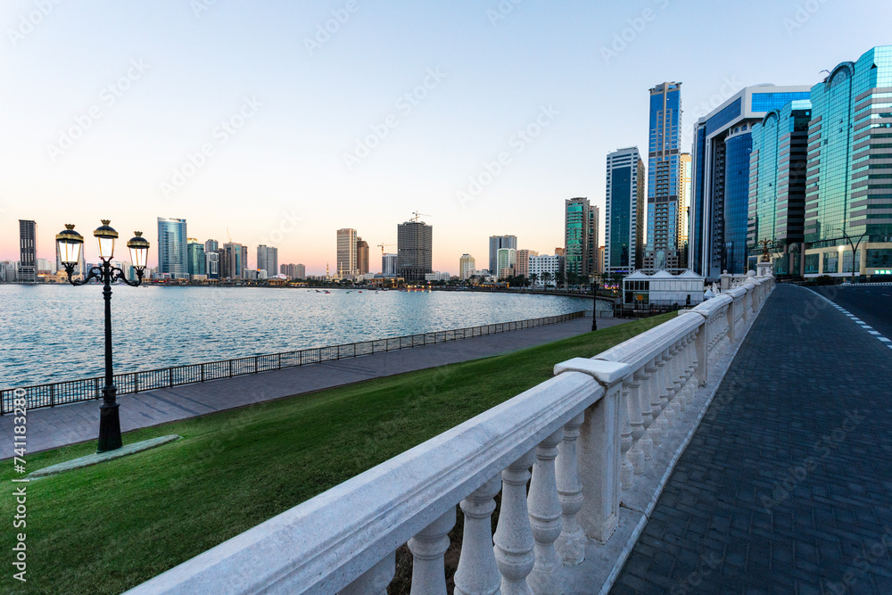 Beautiful view of the Sharjah waterfront at sunset, UAE. Travel vacation in the United Arab Emirates .