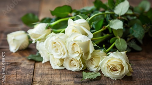 Bouquet of white roses on a wooden background.