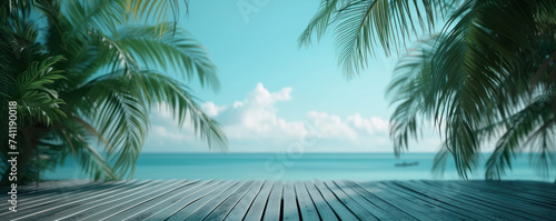 Wooden floor with tropical palm tree on the sea beach and blue sky