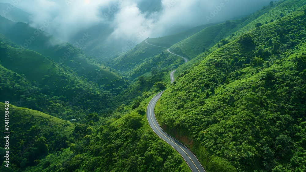 Aerial shot of a curved road on a green mountain in the rainy season Aerial shot of a curved road on a green mountain in the rainy season