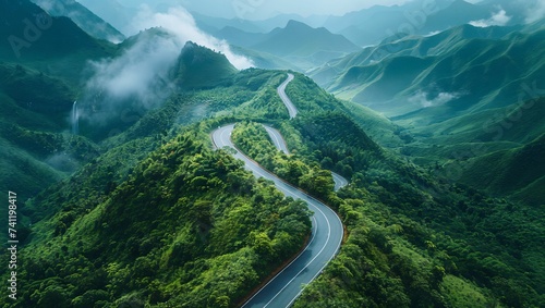 Aerial shot of a curved road on a green mountain in the rainy season photo