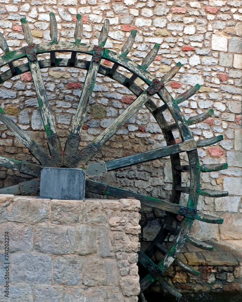 ancient wooden wheel water mill in village