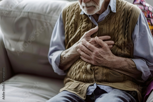 Caucasian elder man with chest pain. Heart attack patient. photo