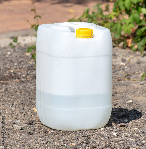 Large plastic container for water on the ground