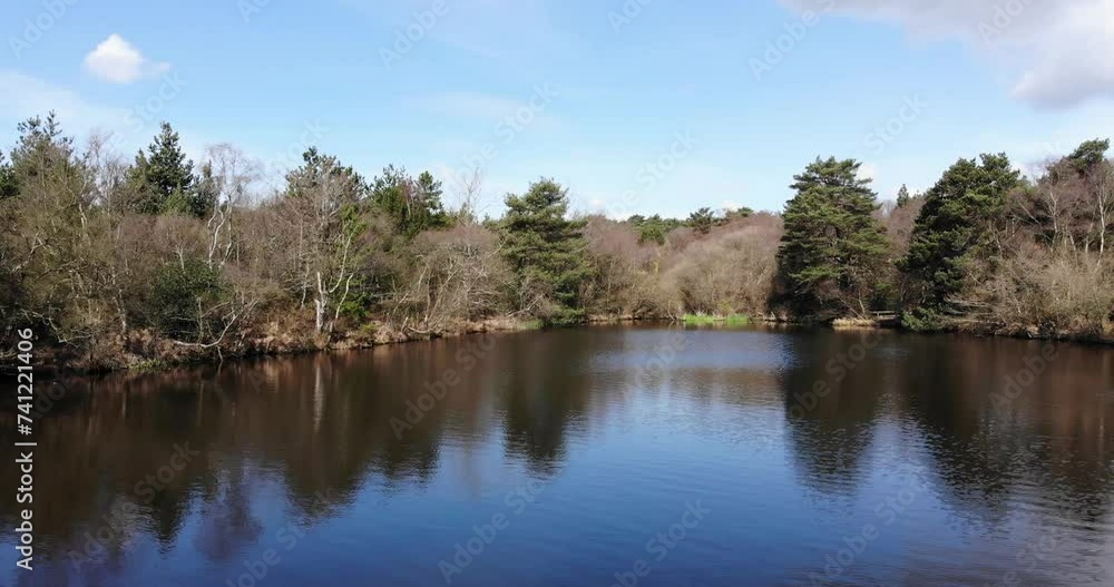 Calm Reflective Squabmoor Reservoir Located In Woodbury Common, East Devon. Aerial Dolly Forward
Calm Reflective Squabmoor Reservoir Located In Woodbury Common, East Devon. Aerial Dolly Forward