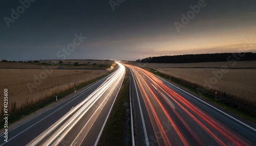 Long and intensive car flow on highway roads during night