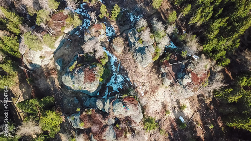 Aerial view of massive rock formation Grossofen surrounded by idyllic forest in Modriach, Hebalm, Kor Alps, border Carinthia Styria, Austria. Refreshing hiking trail in remote Austrian Prealps. Drone photo