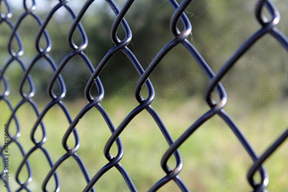 Fototapeta premium Close up view of a black chain link fence