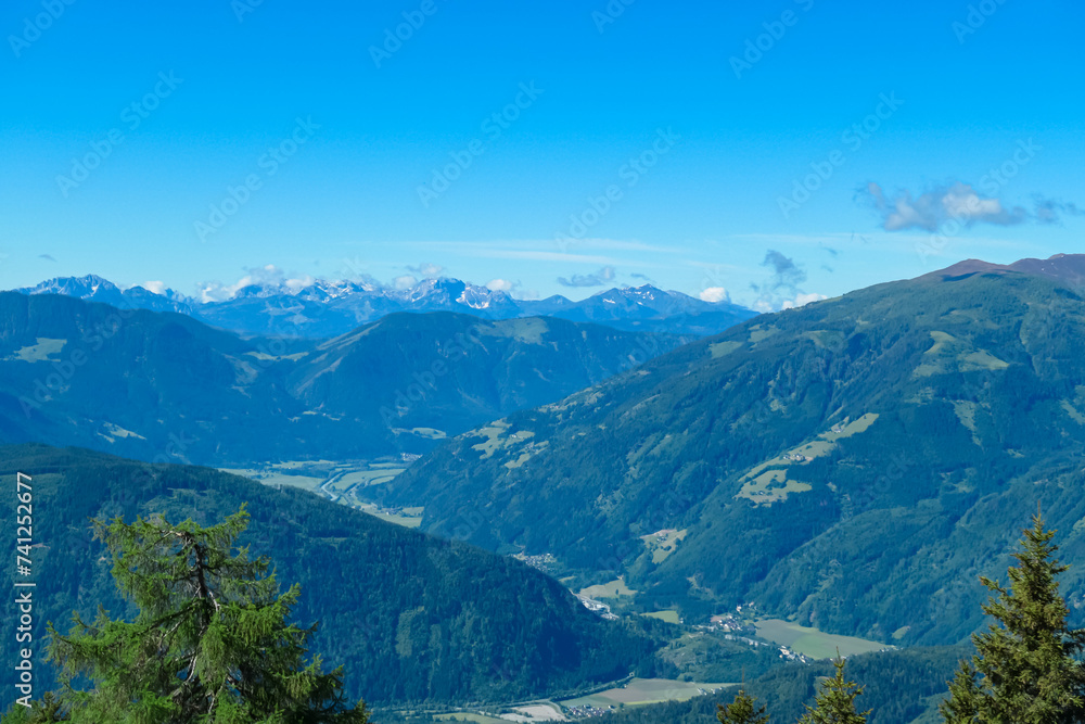 Panoramic view of majestic mountain peaks of Karawanks and Julian Alps seen from Boese Nase in Ankogel Group, Carinthia, Austria. Idyllic hiking trail in remote Austrian Alps in summer. Alpine valley