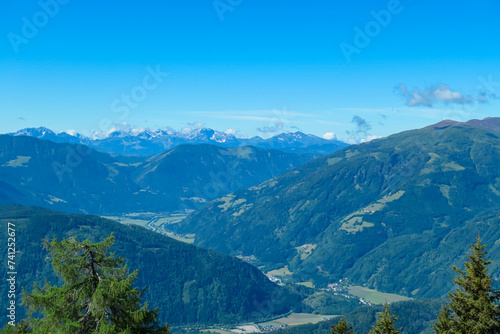 Panoramic view of majestic mountain peaks of Karawanks and Julian Alps seen from Boese Nase in Ankogel Group, Carinthia, Austria. Idyllic hiking trail in remote Austrian Alps in summer. Alpine valley