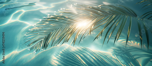 Beach or swimming pool water surface with shadow of tropical leaves Monstera deliciosa, top view. Palm leaves beach summer vacation vacation background concept banner, web banner wallpaper