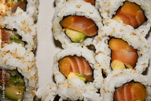 Full plate of maki shushi close up top view with white background.