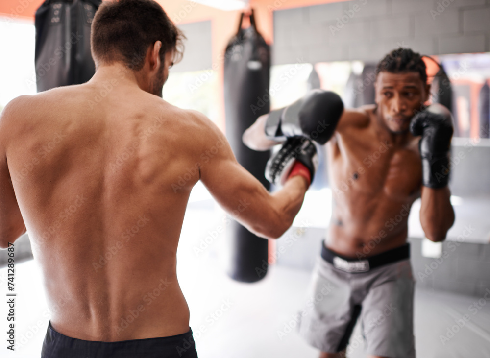 Boxer, coach and training in gym with men for fitness, sport and boxing workout with personal trainer and athlete. Exercise, skill and kickboxing with practice for MMA and challenge with action