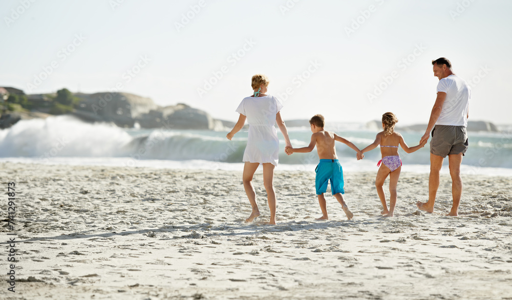 Parents, children and hand holding on beach for travel together at ocean for trip connection, bonding or love. Man, woman and siblings with back view at sea in Florida for vacation, outdoor or family
