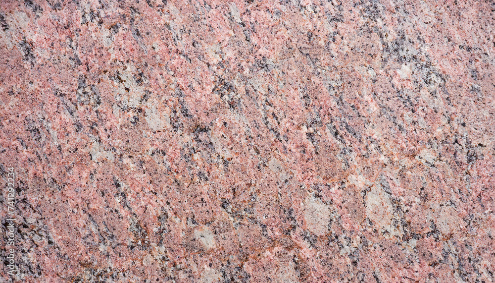 Polished surface of granite with pink hues., texture and background for design Polished surface of granite with pink hues., texture and background for design
