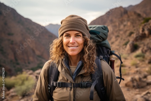 Hiker woman with backpack hiking in the mountains. Adventure and travel concept.