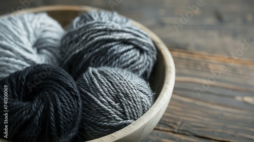 Multi-colored balls of thread for knitting ledat on a wooden table. Aesthetic background for advertising hobby, handmade art.