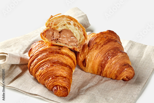 Fluffy chocolate filled croissants on natural linen napkin