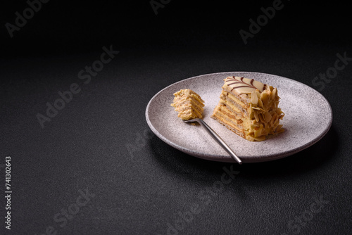 Piece of delicious sweet esterhazy cake with nuts and cream photo