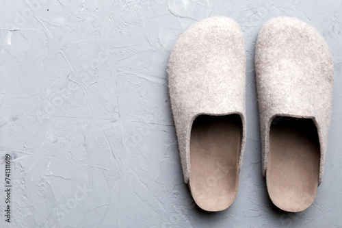Warm winter women woolen slippers on the floor. Copy space for text