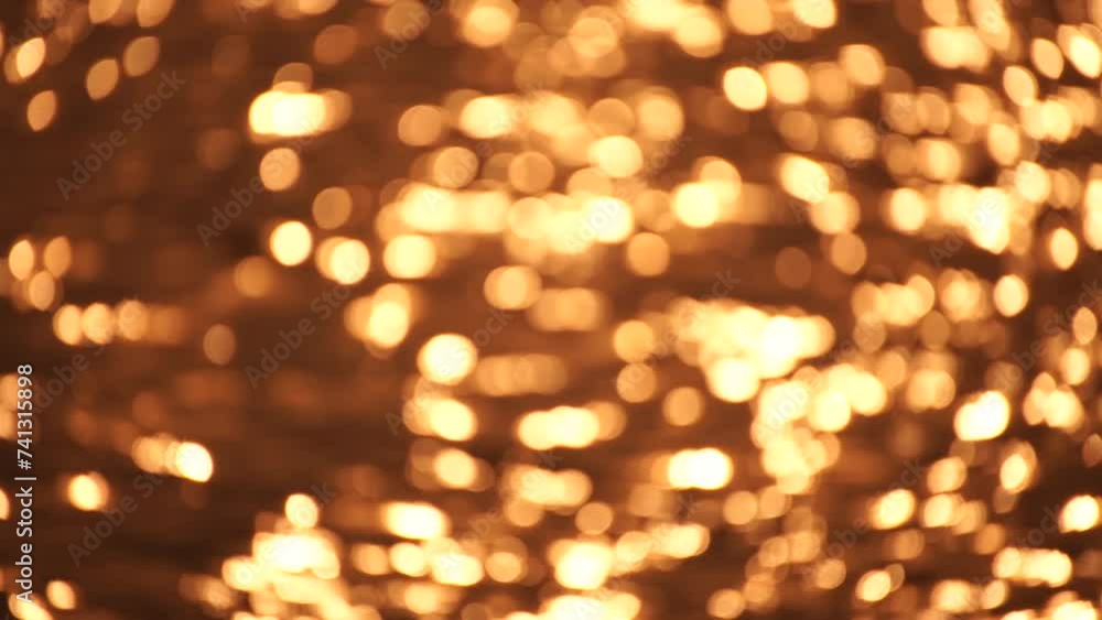 Abstract Blurred video screensaver bokeh golden sea at sunset. The sun reflects and sparkles on the waves. Abstract Blurred video screensaver bokeh golden sea at sunset. The sun reflects and sparkles on the waves.