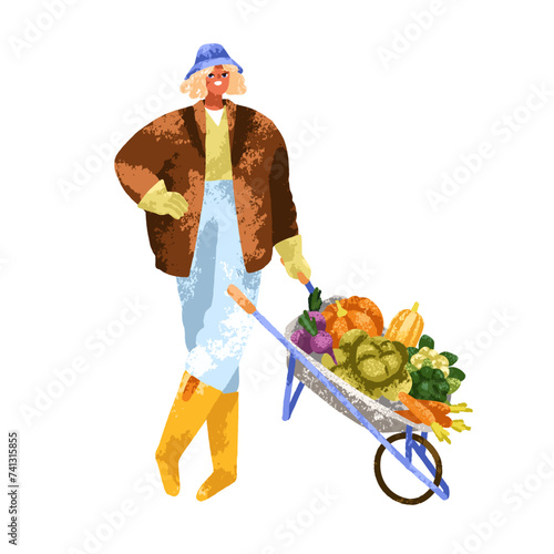 Woman farmer with harvest in wheelbarrow. Happy farm worker standing with pic...