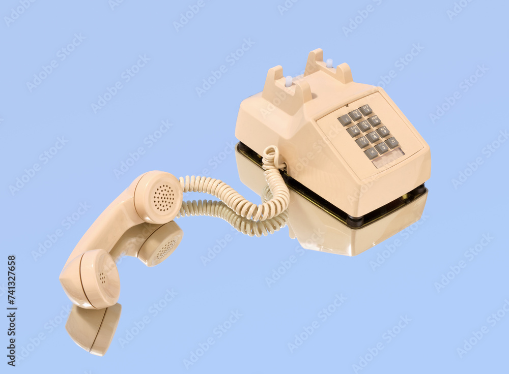 Beige retro phone with gray buttons on the mirror. Idea of business conversations. Beige retro phone with gray buttons on the mirror. Idea of business conversations.