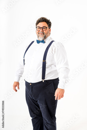 Smiling Gentleman With Suspenders and Bow Tie Against White Background