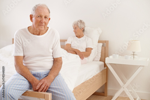 Senior, couple and stress in bedroom with conflict, ignore and crisis in marriage for mental health and retirement. Elderly, woman or man with fight, sad and divorce on bed in home with disagreement