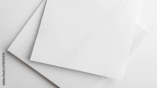 Overhead view of blank white paper cards on a white background, perfect for mockups, presentations, and graphic design layouts.