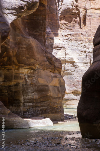 Jordan. Miracle of nature - Wadi el-Mujib gorge. Mesmerizing beauty of multi-colored steep cliffs of canyon. Along bottom of narrow gorge, among rock formations, flows unusually beautiful river,. photo