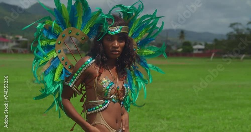 Amidst the lively celebrations of Trinidad's Carnival, a young girl captivates onlookers with her enchanting costume and joyful spirit. photo